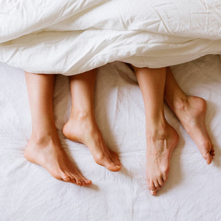 two sets of feet poking out from under white bed sheets the blog post why do women get utis after sex