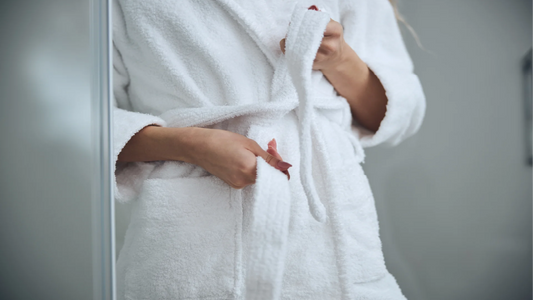 a woman standing in a fluffy white bathrobe. we talk about intimate health and hygiene in particular the impact of lactobacilli bacteria in the vagina