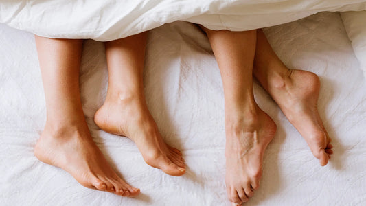 two sets of feet poking out from under white bed sheets the blog post why do women get utis after sex